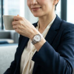 オフィスでセイコールキアを身に着け仕事の合間のコーヒーブレイクでくつろぐ女性。